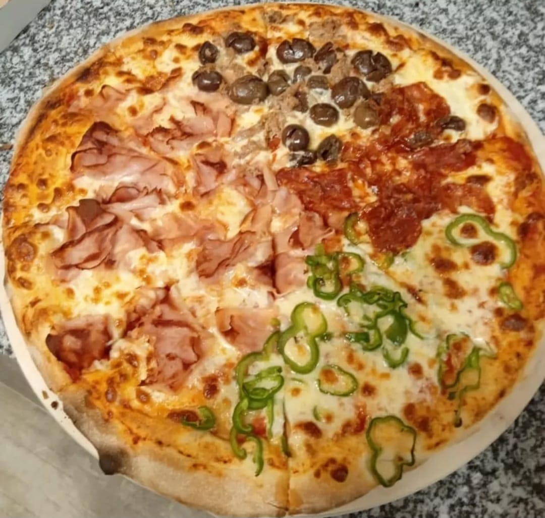 Wood-fired pizza with four toppings: ham, olives, salami and green peppers